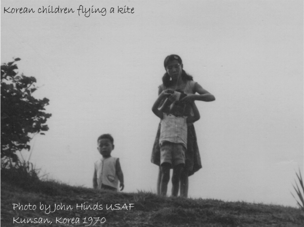 Korean kids flying a kite.